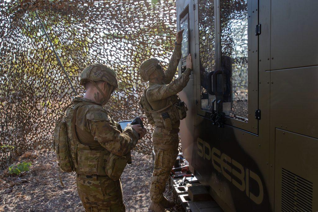 Australian Army Corporal Sean Barton (right) and artisan Naythan Ryan from the 1st Combat Service Support Battalion, are deploying WarpSPEE 3D printers