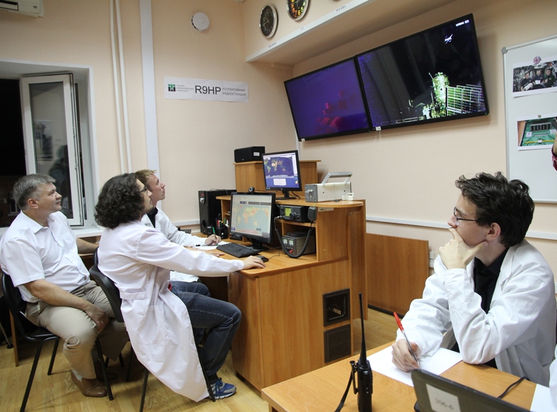 Students from the Mission Control Center (MCC) monitor the launch of the Tomsk-TPU-120 satellite